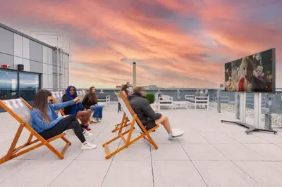 a group of people sitting in chairs on a roof at For Students Only - True Liverpool in Liverpool