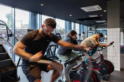 a group of men riding on an exercise bike at For Students Only - True Liverpool in Liverpool