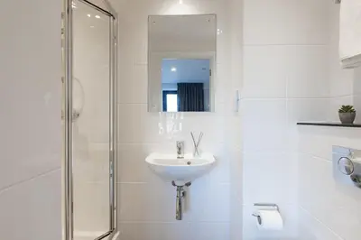 a white bathroom with a sink and a shower at For Students Only - True Liverpool in Liverpool
