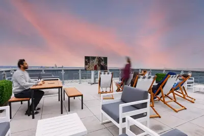 a man sitting at a table on a roof at For Students Only - True Liverpool in Liverpool