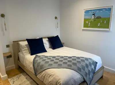 a bedroom with a bed with blue pillows at Auberge in Lytham St Annes