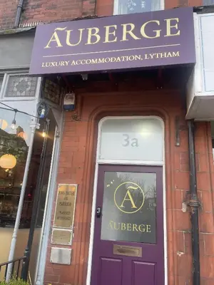 a purple door of a store with a sign above it at Auberge in Lytham St Annes