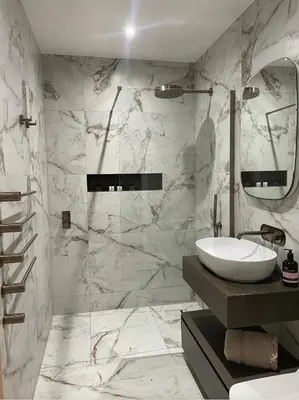 a white bathroom with a sink and a mirror at Auberge in Lytham St Annes