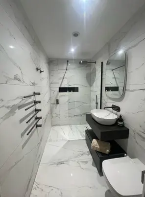 a white bathroom with a sink and a toilet at Auberge in Lytham St Annes