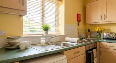 a kitchen counter with a sink and a window at Convenient 2 Bedroom Apartment in Preston w WiFi in Preston