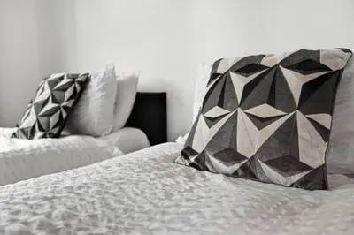 a bed with two pillows on top of it at The Crews Quarters Anfield - Sleeps 9 - Modern in Liverpool