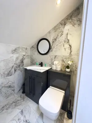 a bathroom with a white toilet and a sink at Cumberland Street Apartments by Happy Days in Liverpool