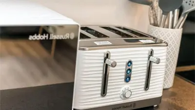 a white stove top oven sitting next to a toaster at Modern 2BR Near Liverpool ONE & Parking in Liverpool