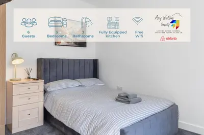 a bedroom with a bed and a dresser and a wall with signs at Luxury 3-Bedroom, 3-Bath Home in Dalton-in-Furness in Dalton in Furness