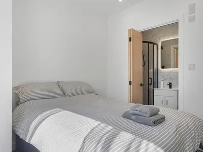 a bedroom with a bed with two towels on it at Luxury 3-Bedroom, 3-Bath Home in Dalton-in-Furness in Dalton in Furness