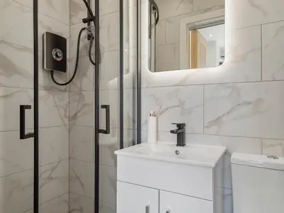 a white bathroom with a sink and a shower at Luxury 3-Bedroom, 3-Bath Home in Dalton-in-Furness in Dalton in Furness