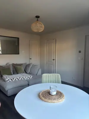a living room with a couch and a table at 1 Bed Apartment With Private Garden in Southport