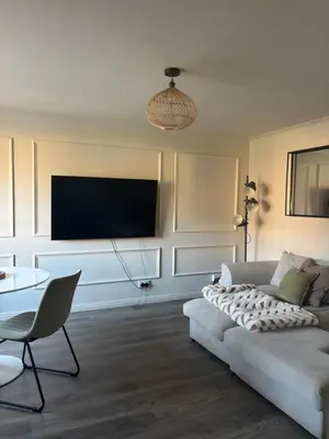 a living room with a couch and a tv at 1 Bed Apartment With Private Garden in Southport