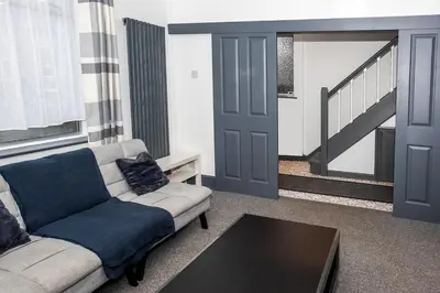 a living room with a couch and a table at Stylish 3 bedroom Wigan House sleeps 7 in Pemberton