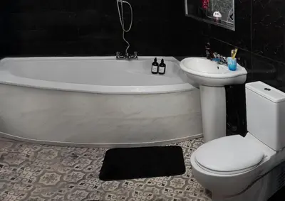 a bathroom with a tub and a toilet and a sink at Stylish 3 bedroom Wigan House sleeps 7 in Pemberton