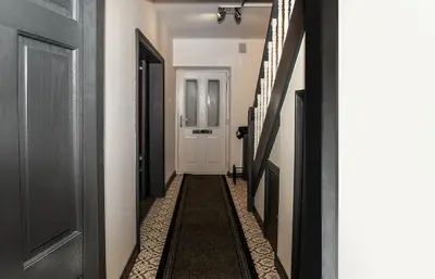 a hallway with a white door and a hallway with a hallwayngthngthngthngth at Stylish 3 bedroom Wigan House sleeps 7 in Pemberton