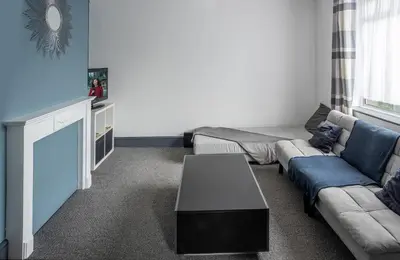 a living room with a couch and a table at Stylish 3 bedroom Wigan House sleeps 7 in Pemberton