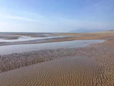 a beach with ripples in the sand and water at Mount Pleasant Town House Gem in Barrow
