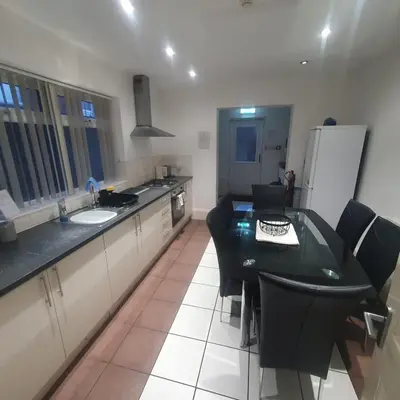 a kitchen with a black table and black chairs at Mount Pleasant Town House Gem in Barrow