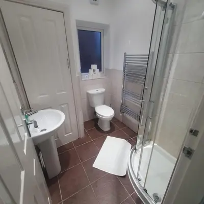 a bathroom with a toilet and a sink and a shower at Mount Pleasant Town House Gem in Barrow