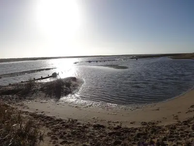 a beach with the sun reflecting in the water at Seaview Cottage Lake District Coast in Millom