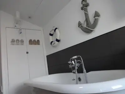 a bathroom with a sink and a bath tub at Seaview Cottage Lake District Coast in Millom