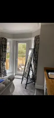 a room with a easel in a room with a window at Cambridge Villa St Annes in Lytham St Annes