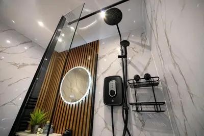a bathroom with a microphone and a mirror at Preston Central in Preston