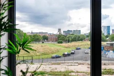 a view from a window of a parking lot with cars at Modern 2BR 2BA Apartment in Liverpool - Sleeps 4 in Liverpool