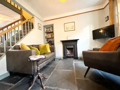 a living room with two couches and a fireplace at Ulverston Cozy Cottage Retreat in Ulverston