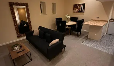 a living room with a couch and a table at City Centre Duplex Apartment Liverpool in Liverpool