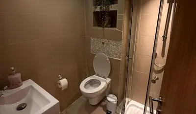 a small bathroom with a toilet and a sink at City Centre Duplex Apartment Liverpool in Liverpool
