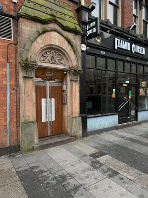 an old building with a wooden door on a street at City Centre Duplex Apartment Liverpool in Liverpool