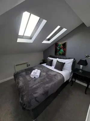 a bedroom with a bed with two towels on it at City Centre Duplex Apartment Liverpool in Liverpool