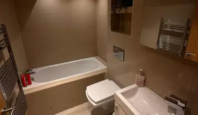 a bathroom with a tub and a toilet and a sink at City Centre Duplex Apartment Liverpool in Liverpool