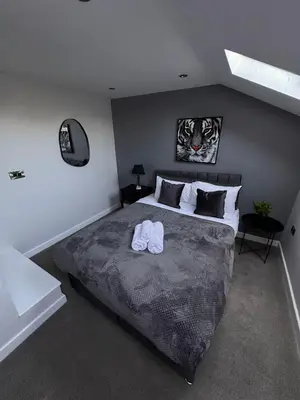 a bedroom with a large bed with two towels on it at City Centre Duplex Apartment Liverpool in Liverpool