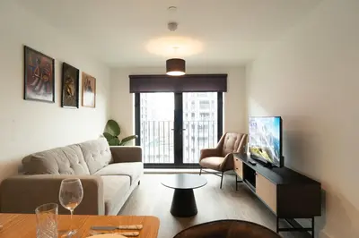 a living room with a couch and a tv at Modern 2BED 5th Floor Apartment Central Liverpool in Liverpool