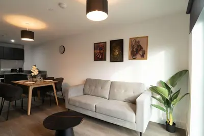 a living room with a couch and a table at Modern 2BED 5th Floor Apartment Central Liverpool in Liverpool
