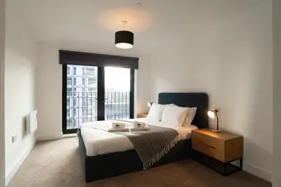 a bedroom with a large bed and a window at Modern 2BED 5th Floor Apartment Central Liverpool in Liverpool