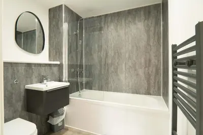 a bathroom with a tub and a toilet and a sink at Modern 2BED 5th Floor Apartment Central Liverpool in Liverpool