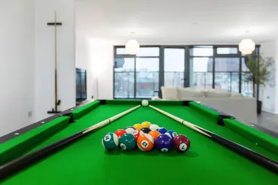 a pool table with balls on it in a living room at Skyline Penthouse- Views, Games 2 Parking Spaces in Liverpool