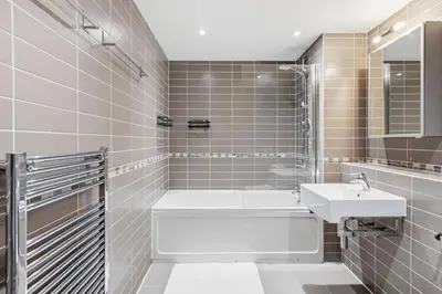 a bathroom with a tub and a sink at Skyline Penthouse- Views, Games 2 Parking Spaces in Liverpool