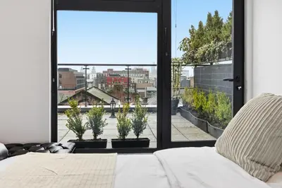 a bedroom with a bed and a large window at Skyline Penthouse- Views, Games 2 Parking Spaces in Liverpool