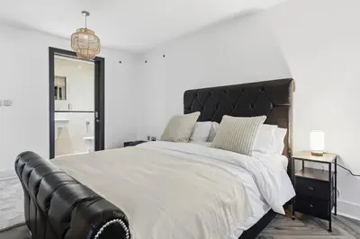 a bedroom with a large bed with a leather headboard at Skyline Penthouse- Views, Games 2 Parking Spaces in Liverpool