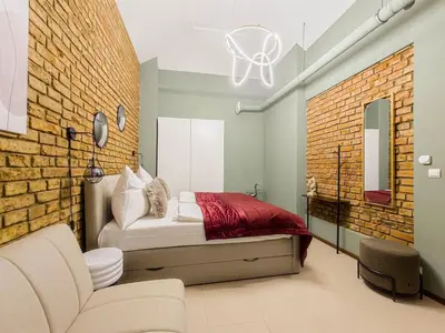 a bedroom with a bed and a brick wall at Apartment Wilkinson in Liverpool