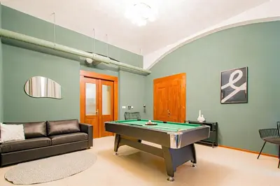 a living room with a pool table and a couch at Apartment Wilkinson in Liverpool