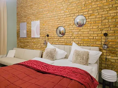 a bedroom with a bed and a brick wall at Apartment Wilkinson in Liverpool