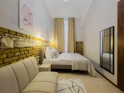 a living room with a bed and a couch at Apartment Wilkinson in Liverpool