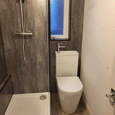 a small bathroom with a toilet and a shower at Ince House in Liverpool