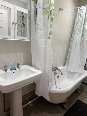 a bathroom with a sink and a shower curtain at Ince House in Liverpool